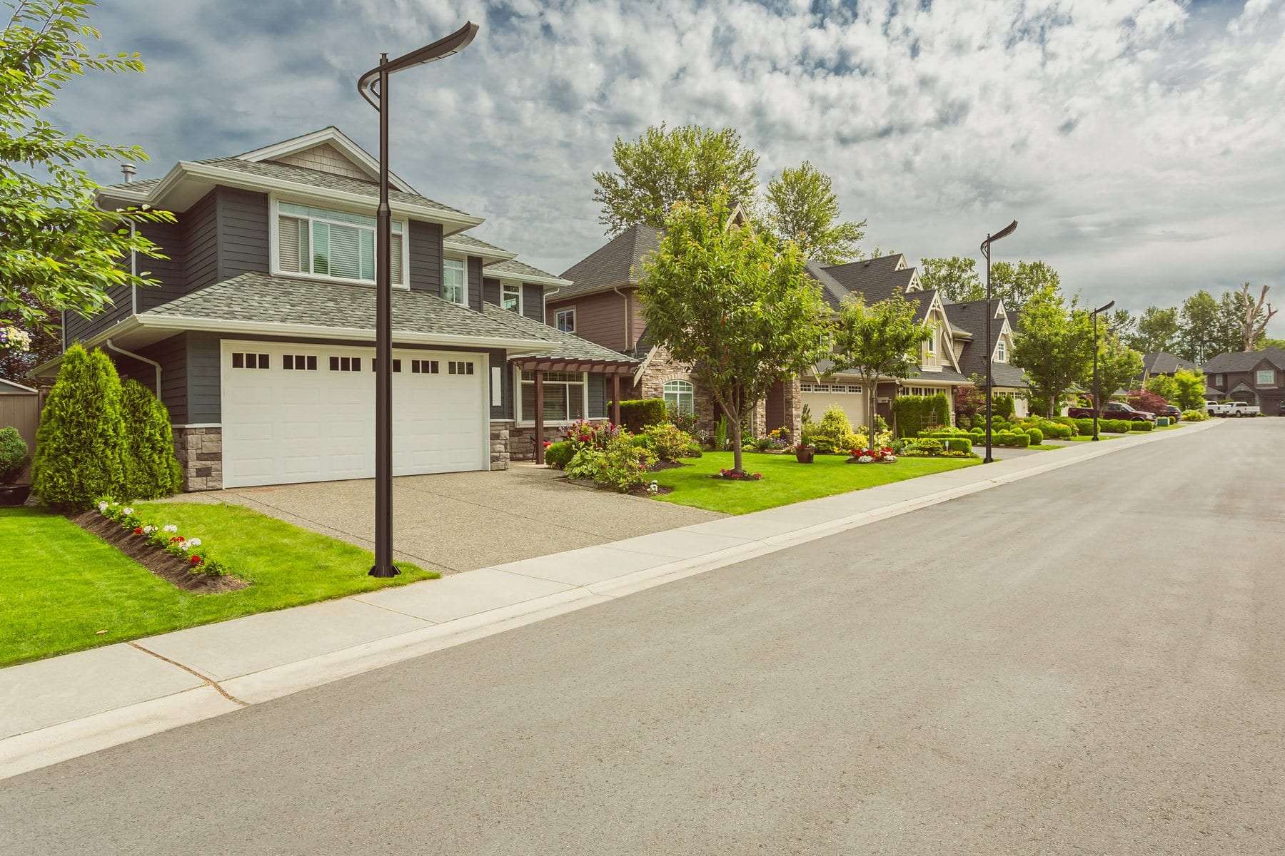 Ornamental smart poles on a residential street lined with houses